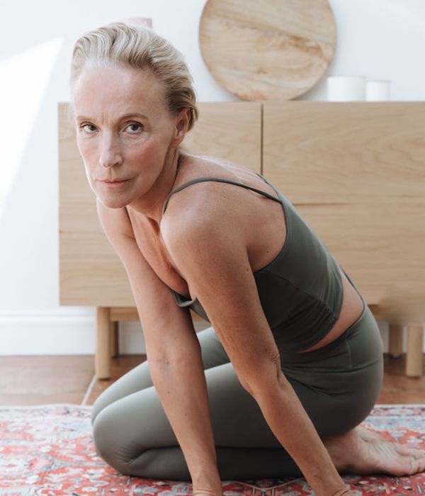 Person stretching gracefully in a minimalist setting.